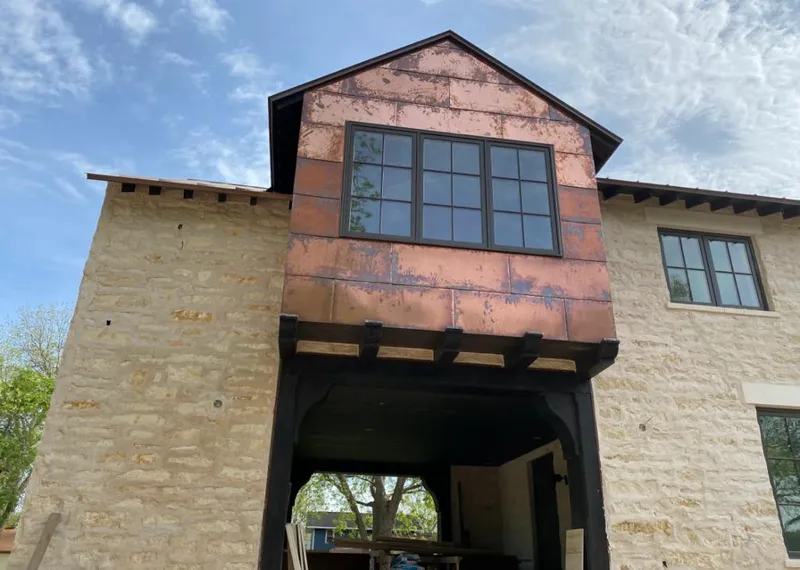 Copper metal panel facade on a stone building for Metal Roof Coating in Quartz Hill