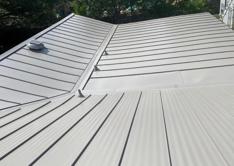 Solar attic fan installed on a metal roof for Roof Ventilation in Quartz Hill